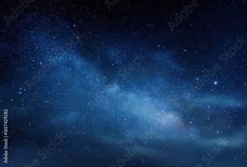 Clear night sky with a prominent view of the Milky Way and scattered stars over a dark landscape