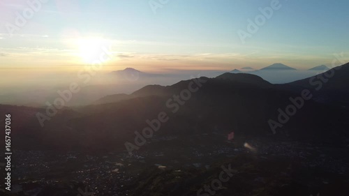 Sikunir Golden Sunrise, Indonesia, captured on August 19, 2025. Majestic golden light illuminating mountain peaks above a sea of clouds, with silhouettes of rolling hills and clear morning sky.