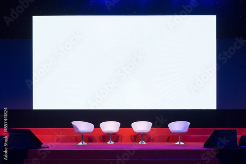 chairs on stage with led background