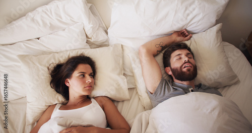 Obraz na płótnie Couple, bed and woman annoyed with man for snoring, loud or noise with frustrated partner in home