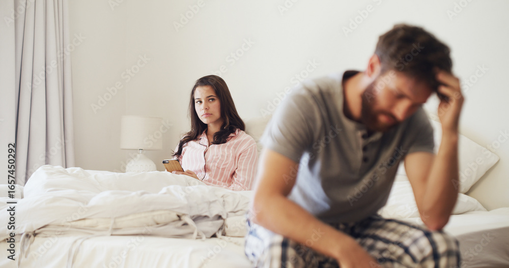Fototapeta premium Frustrated woman, argument and conflict with stress in bed for cheating affair or disagreement. Upset, person or toxic relationship with phone in bedroom dispute for divorce or trust issues in home