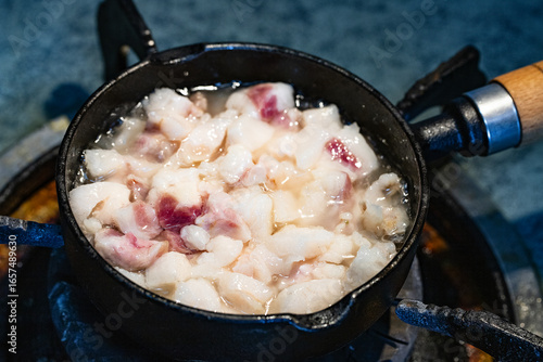 rander lard with small black iron pan