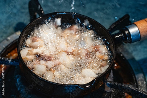 rander lard with small black iron pan