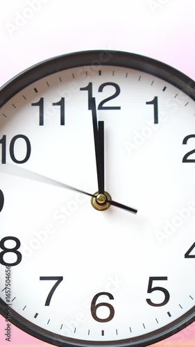 Wallpaper Mural 4K footage vertical video close-up view wall clock shows the time precisely at 11:59, set against soft pink gradient background.  Torontodigital.ca