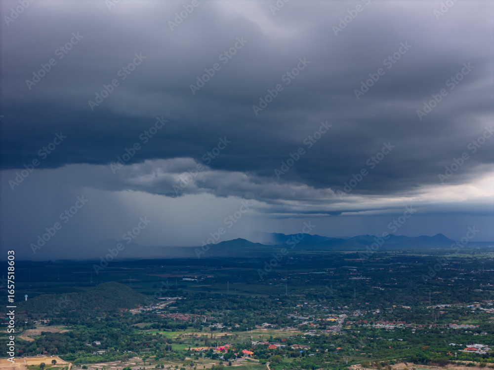 Obraz premium Aerial View of Rainfall and Thunderstorm Clouds Over Tropical Valley and Mountain Ranges