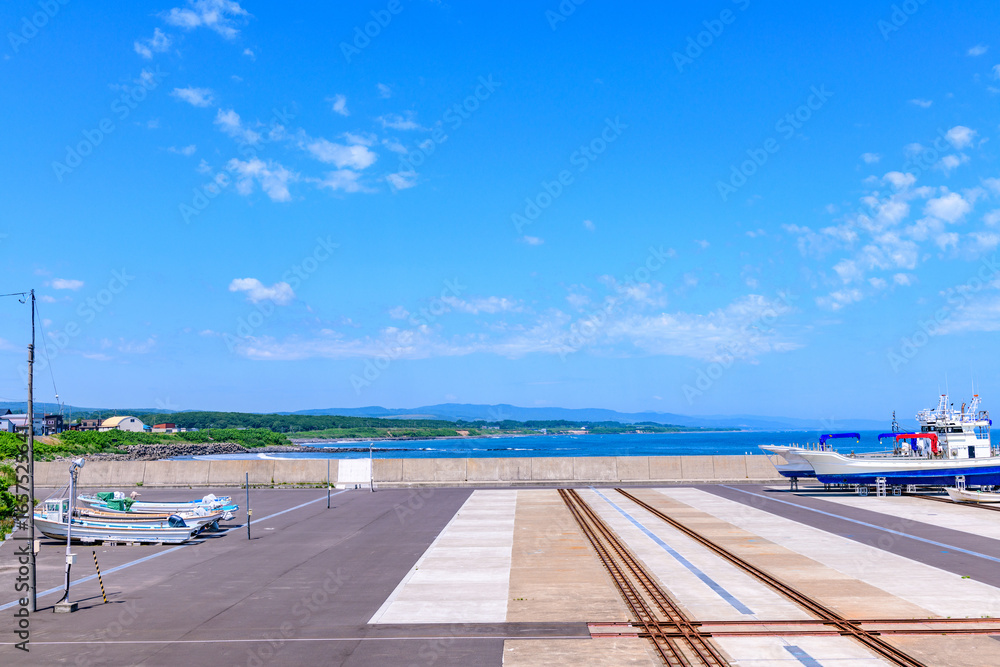 Fototapeta premium Otoshibe District, Esashi Fishing Port and Coastline under June Blue Sky, Hokkaido, Japan 