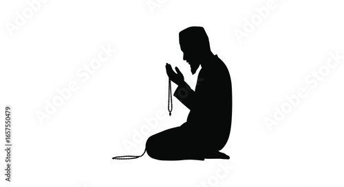 A person kneeling in prayer with a rosary in their hands silhouette