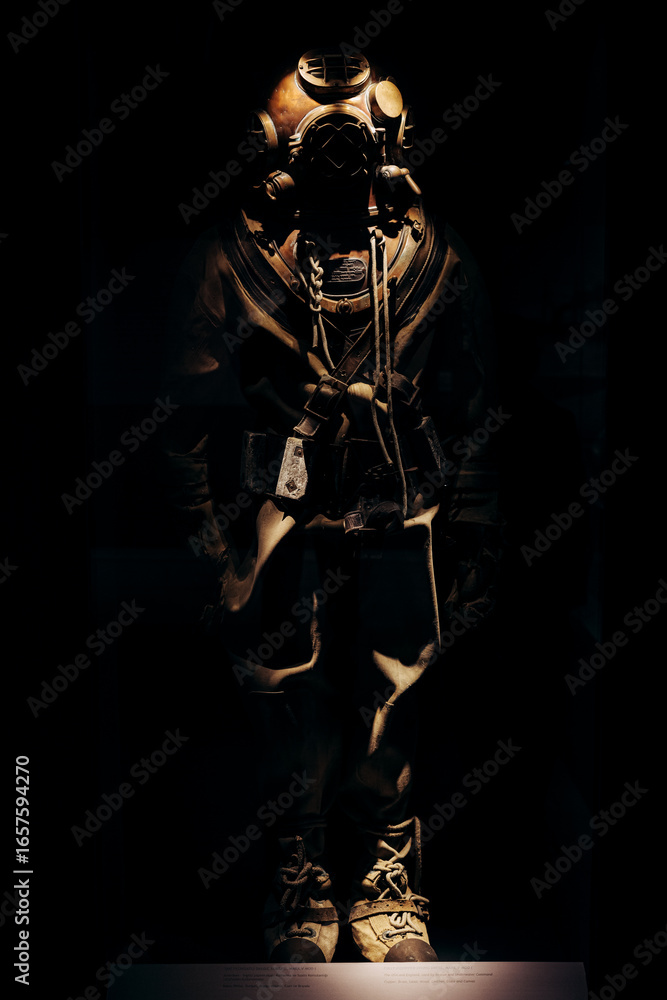 Fototapeta premium Vintage Deep-Sea Diving Suit Displayed in Dark Background