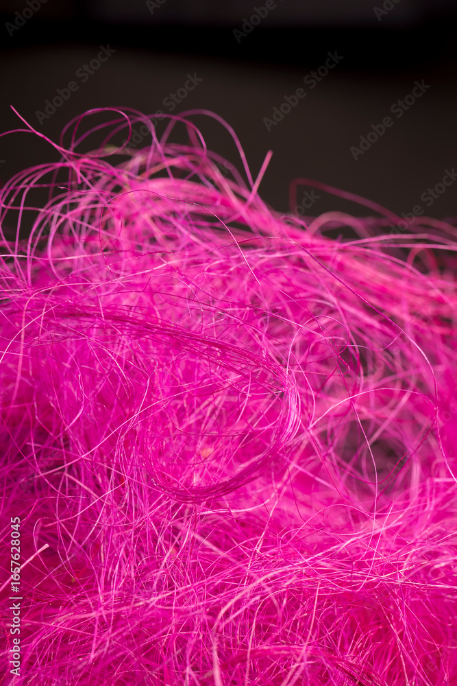 Obraz premium pink threads dyed red for decorative work and creative work of artisans, close up