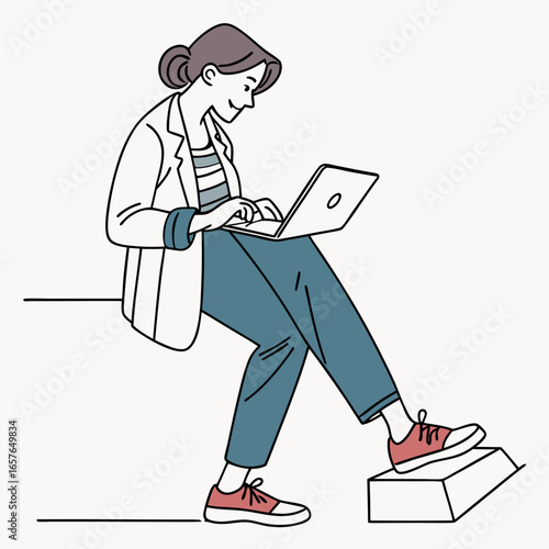 Woman in blazer and sneakers typing on laptop working casual