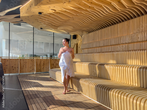 Model in sauna. Sunlit walk. Wooden waves