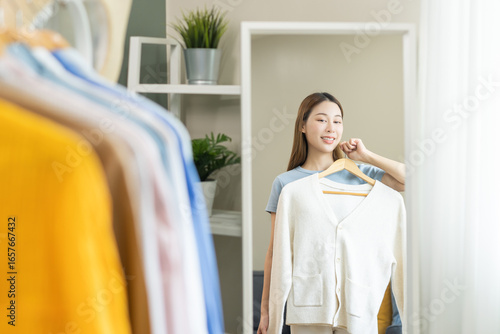 Konstfotografi Choose clothes to wear, attractive asian young woman, girl try on appare, happy choice of shirt, female outfit on hanger in wardrobe in room closet at home