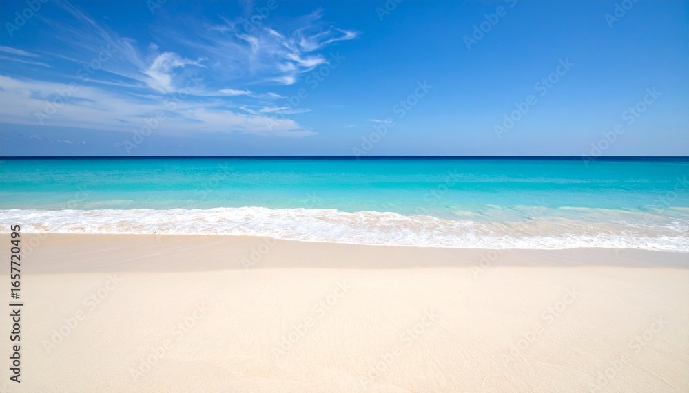 Fototapeta premium A beautiful beach with white sand and turquoise water under a blue sky.