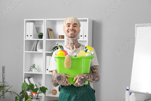 Male janitor with bucket of...