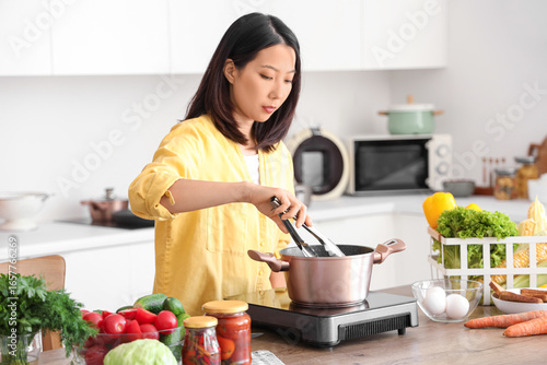 Young Asian woman cooking d...