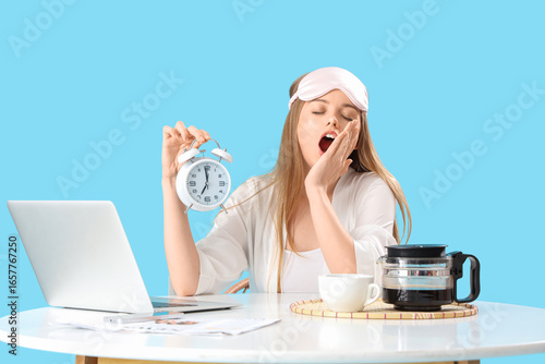 Sleepy young woman with ala...