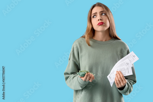 Upset young woman with mone...
