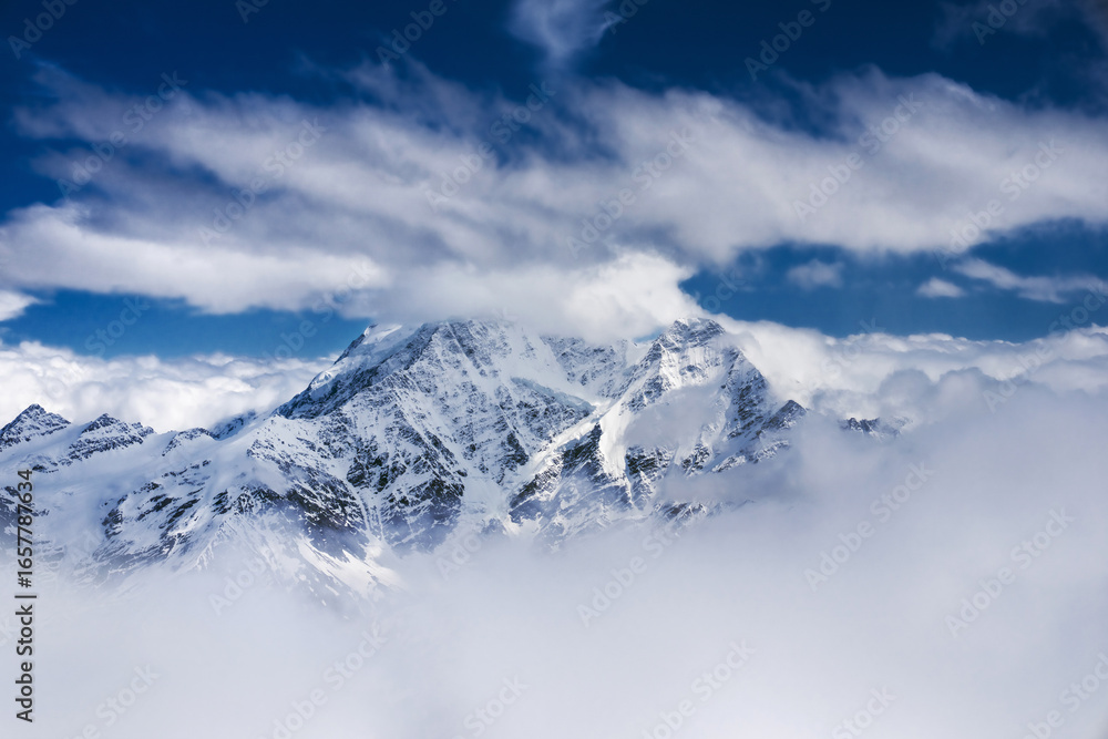 Obraz premium Caucasian mountains Donguz-orun and Nakra summits in clouds. Main Caucasus range, view from the Mt. Elbrus slope.