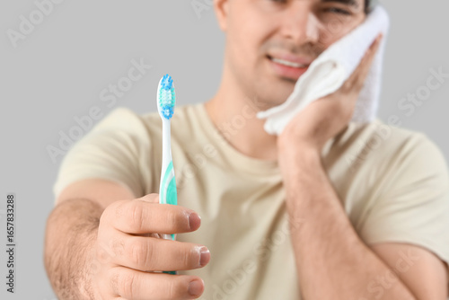 Young man with brush and to...