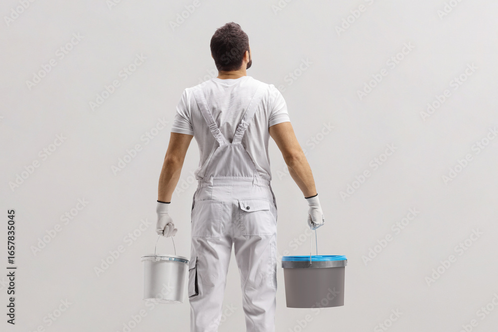 © Ljupco Smokovski - Rear view shot of a painter holding buckets © Ljupco Smokovski - Rear view shot of a painter holding buckets