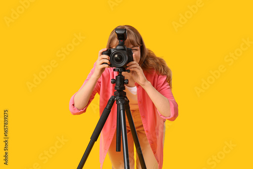 Young woman taking photo wi...