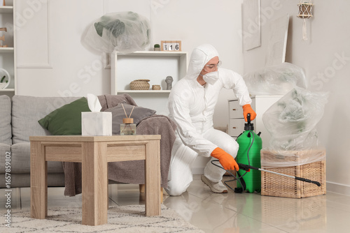 Male worker disinfecting fl...