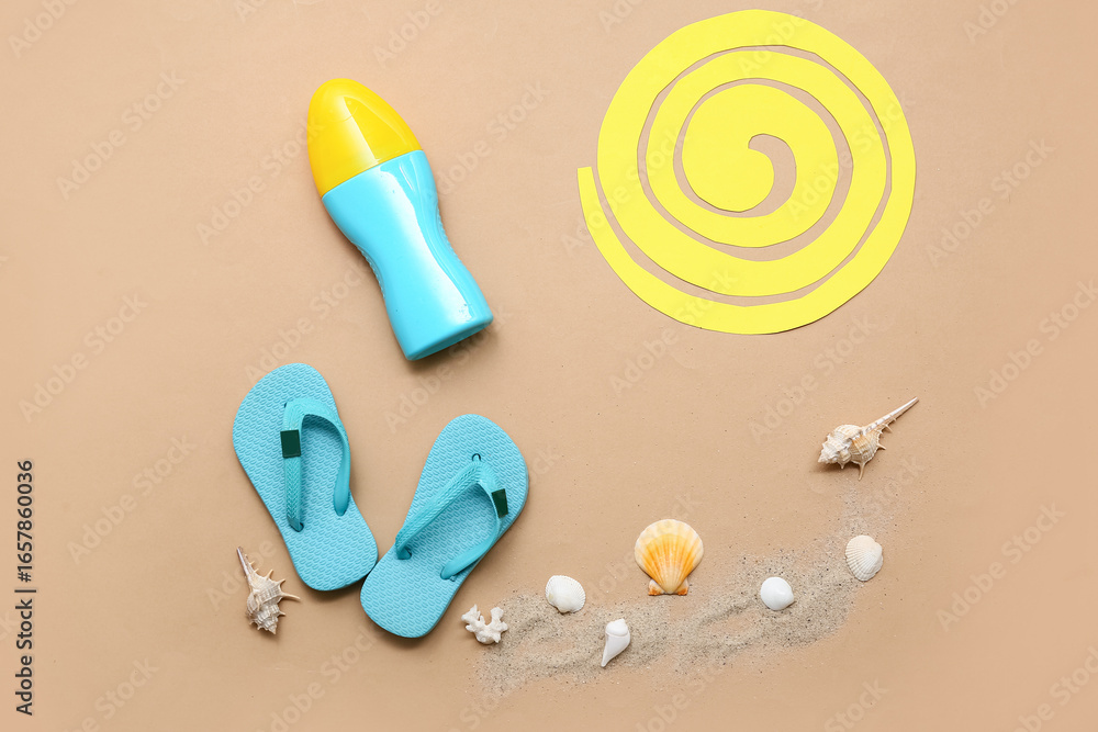 Fototapeta premium Bottle of sunscreen and flip-flops on brown background