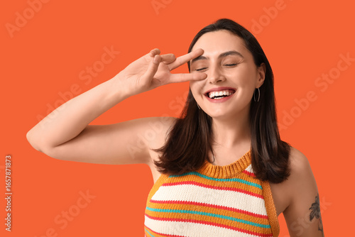 Smiling young woman showing...