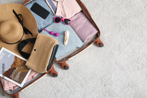 Open suitcase with clothes,...