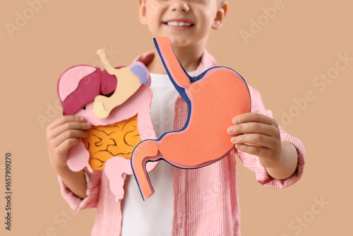 Little boy with paper diges...