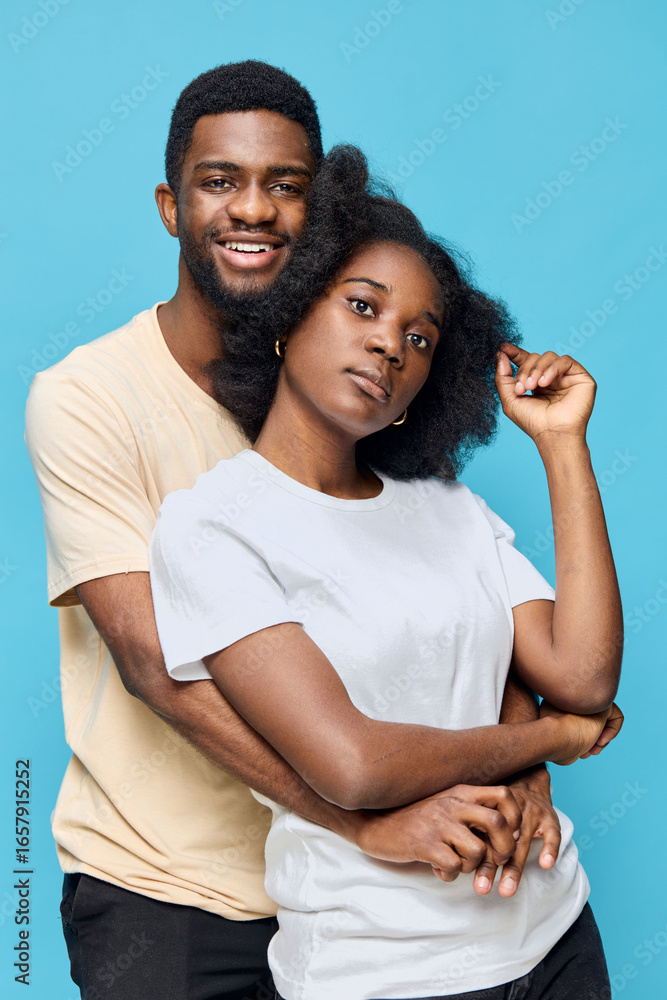Fototapeta premium Happy couple embracing against a blue background, showcasing love and connection in a vibrant and modern style
