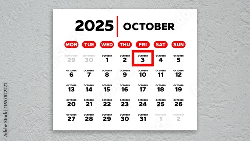 The date October 3rd marked with a red cursor on the wall calendar 2025