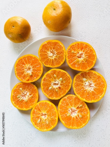 Freshly Cut Tangerines on a White Plate