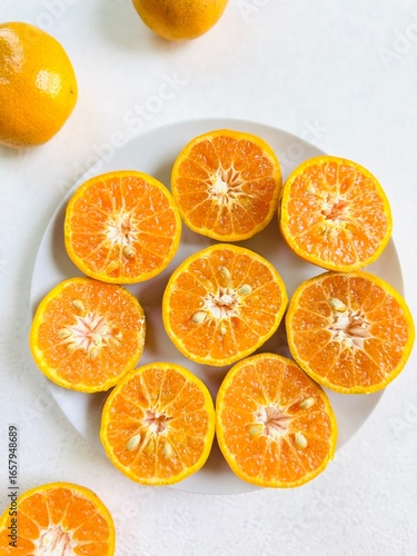 Top View of Freshly Cut Tangerines on Plate