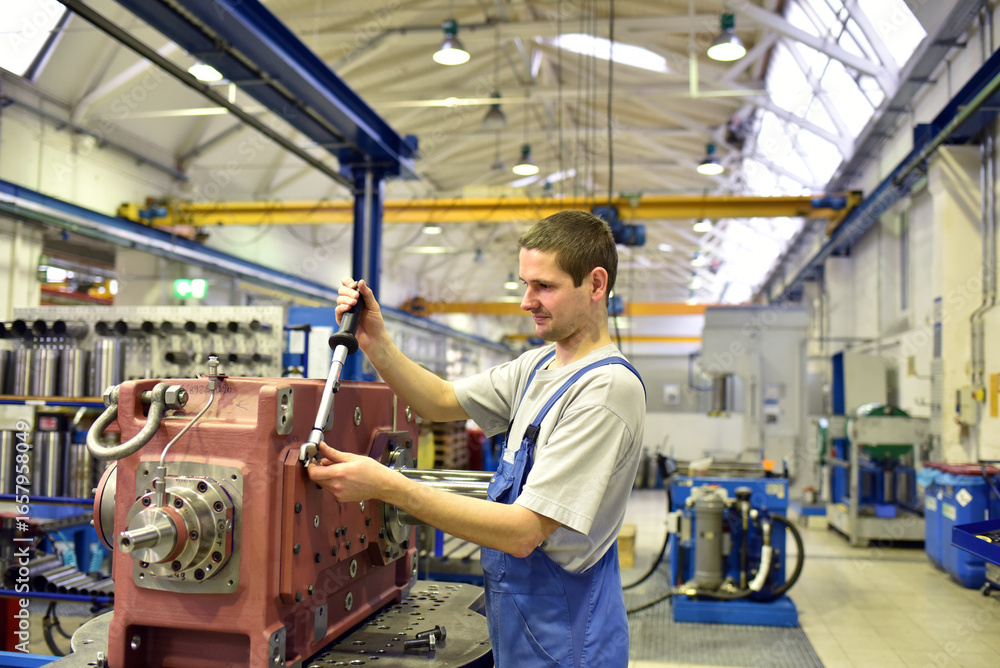 modern mechanical engineering - gear manufacturing factory - assembly by young workers modern mechanical engineering - gear manufacturing factory - assembly by young workers