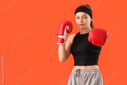 Sporty young woman boxing o...