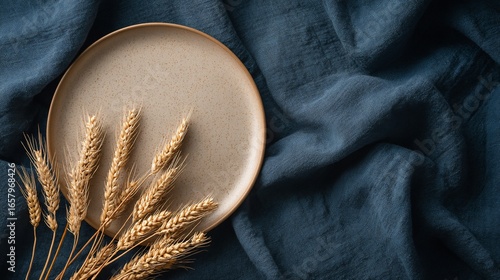 Wallpaper Mural Beige plate with wheat stalks on blue cloth; top-down view Torontodigital.ca