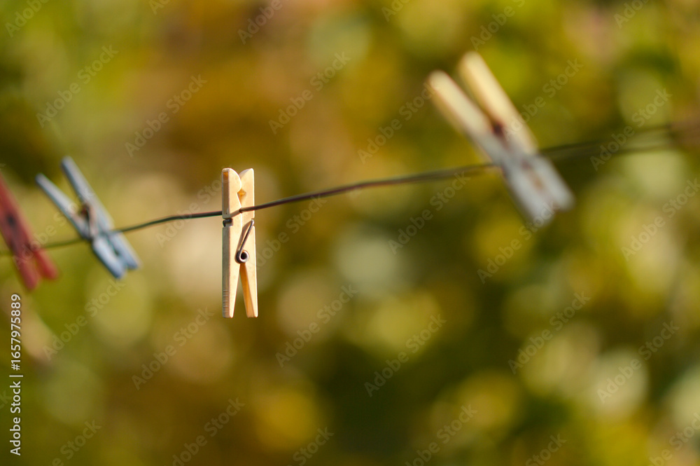 colorful plastic clothes clips hanging on the metal rope colorful plastic clothes clips hanging on the metal rope