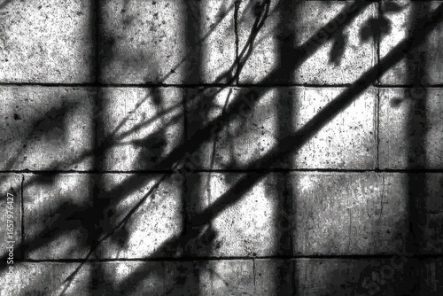Abstract shadows cast on a light gray brick wall