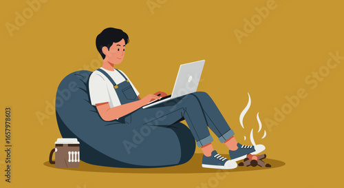 Young person working remotely on laptop from a comfy bean bag, enjoying a cozy indoor campfire and hot drink. Modern work-life balance and flexible lifestyle.