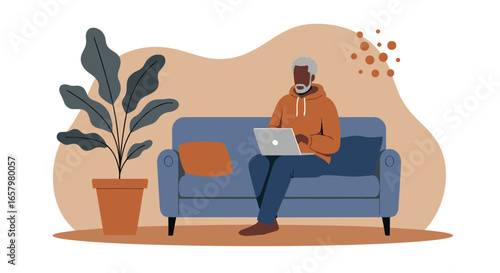 A relaxed senior Black man works on his laptop from the comfort of his couch at home, embodying modern remote work and a digital lifestyle.