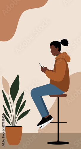 Modern person casually sitting on a stool, absorbed in their smartphone in a minimalist, earthy-toned space with a plant. Represents digital connectivity, relaxation, and contemporary lifestyle.