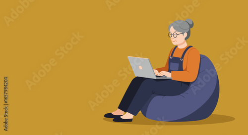 An active senior woman comfortably uses her laptop on a bean bag chair, symbolizing remote work, digital learning, and modern independent living.
