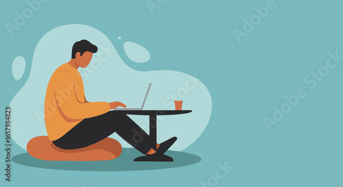 Young man working remotely on his laptop with a coffee, sitting comfortably on a cushion. Ideal for modern work, freelance, and relaxed lifestyle concepts.
