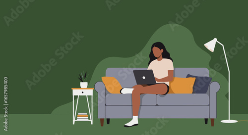 Young woman working from home on her laptop, comfortably seated on a sofa. Illustrates remote work, online learning, or casual digital lifestyle.