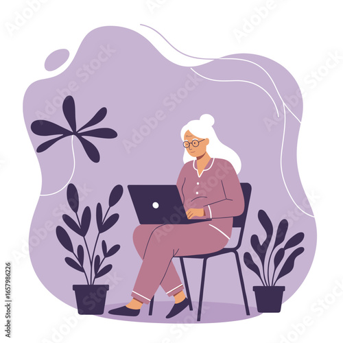 Senior woman in pajamas happily using laptop at home, embracing technology for remote work, leisure, or online learning. Modern elderly lifestyle.
