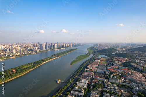 Wallpaper Mural Aerial view captures the sprawling urban landscape of Changsha City, China, with its winding river and prominent green island. Torontodigital.ca