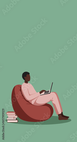 Relaxed African American man works on laptop from a comfy bean bag chair at home. Ideal for remote work, online learning, or digital lifestyle concepts.