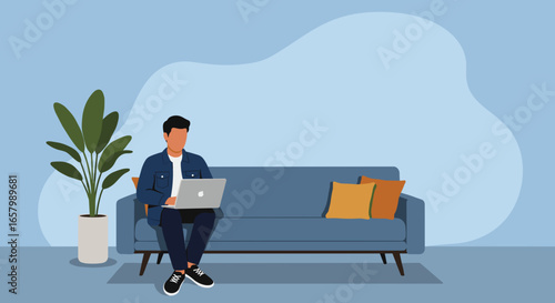 Young man working remotely on his laptop from the comfort of his home sofa. Ideal for themes of flexible work, freelance, and modern lifestyle.