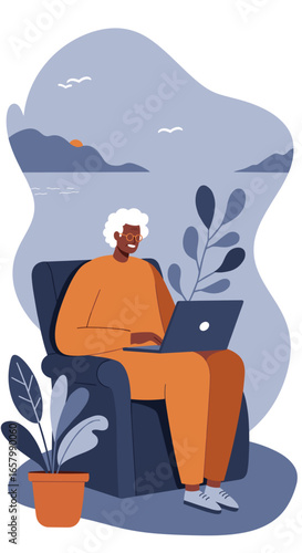 Happy senior adult uses laptop from a cozy armchair. Represents remote work, online learning, or leisurely digital connection from home.